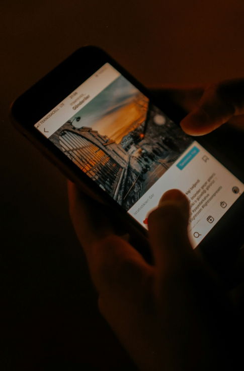 a person holding a cell phone in their hand